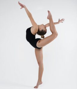 A skilled ballet dancer demonstrating flexibility and strength in a studio setting.